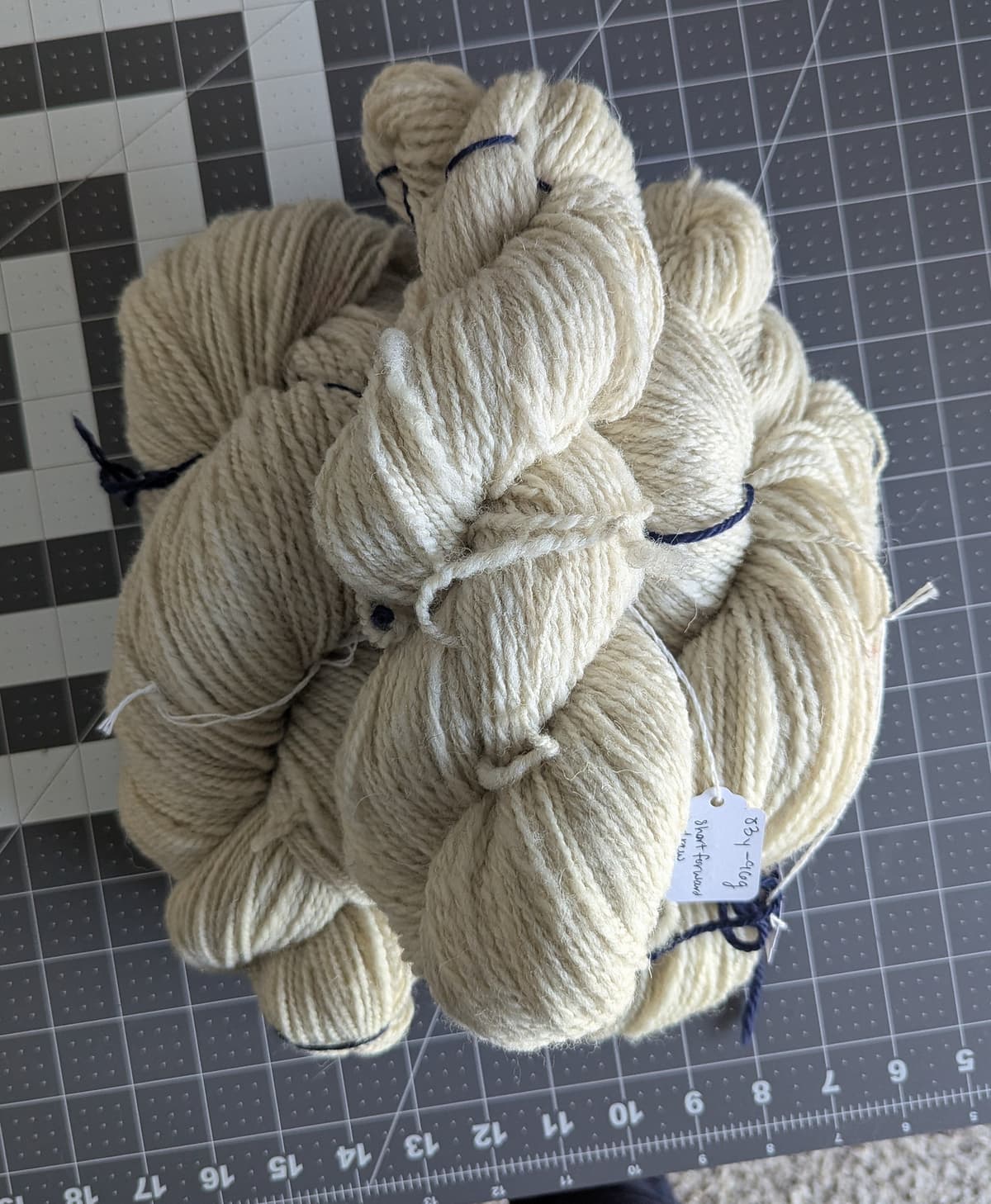 Three skeins of white handspun wool yarn